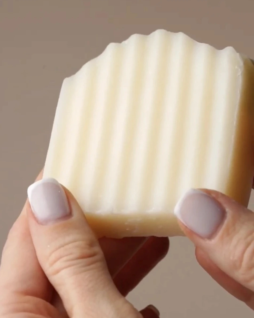 Tallow shampoo bar in hands